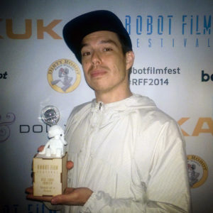 ElectroSpit member, Pete Miser with the Botsker for Best Robot Identity at the 2014 Robot Film Festival.